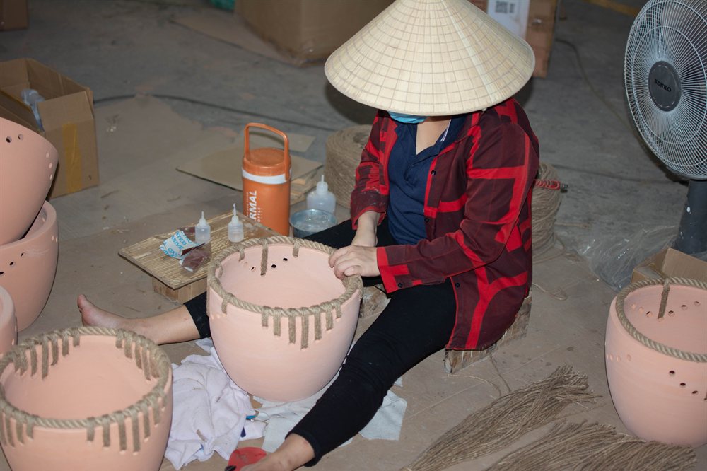 Artisan finishing a terracotta pot by hand